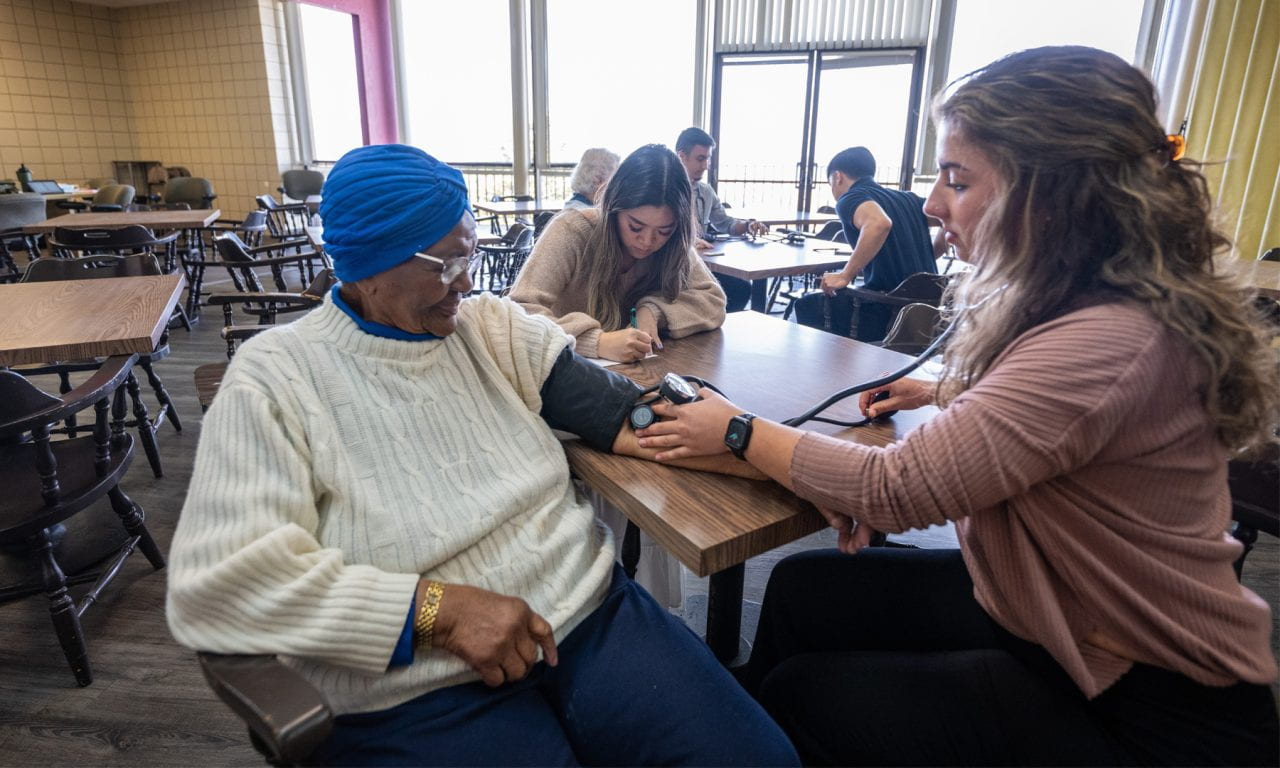 RN-BSN student demonstrates the donning of PPE.