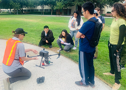 students working with drone