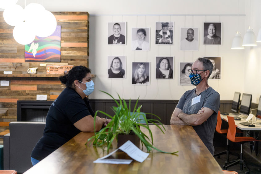 Recovery cafe volunteers chatting in the sitting area.
